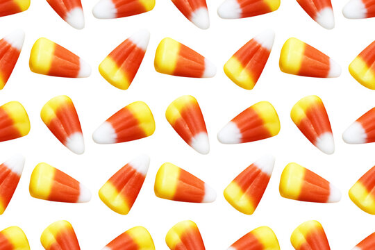 Repeating seamless pattern of candy corn pieces on transparent background	