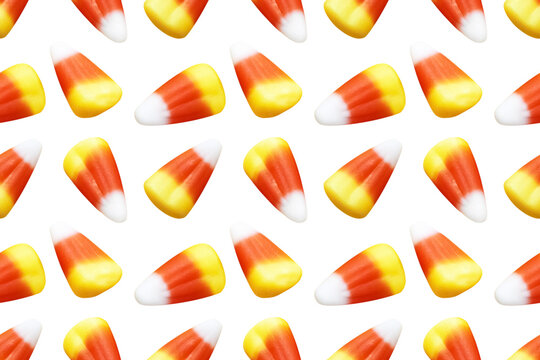 Repeating seamless pattern of candy corn pieces on transparent background	