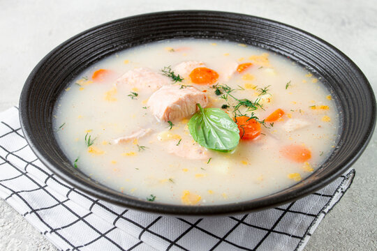 black bowl of soup , Finnish fish soup, lohikeito soup, creamy fish soup,
