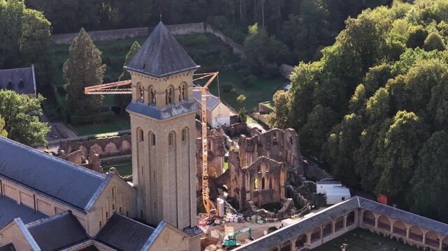 Aerial view of Orval Abbey tower and historic ruins during restoration work