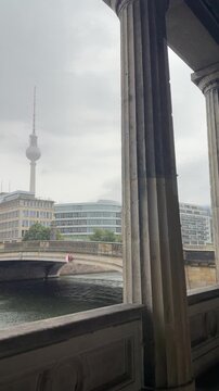 Beautiful Berlin cityscape with TV Tower, Friedrichs bridge over Spree river and giant columns near Old National gallery. Heart of old Berlin city center in typical moody rainy weather.Germany tourism