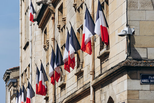 French tricolor flags displayed on the facade of the Libourne town hall in Libourne, France, on July 14, 2026