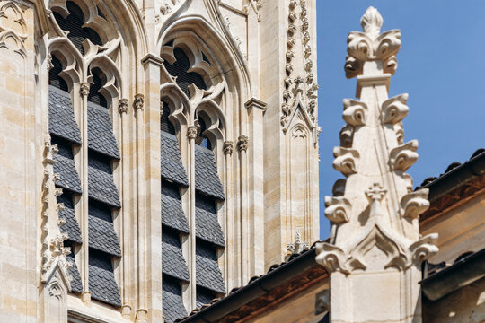 Neo-Gothic tower and ornate stone facade of Saint-Jean-Baptiste Church in Libourne, Nouvelle-Aquitaine, France