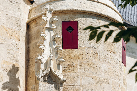 Neo-Gothic tower and ornate stone facade of Saint-Jean-Baptiste Church in Libourne, Nouvelle-Aquitaine, France.
