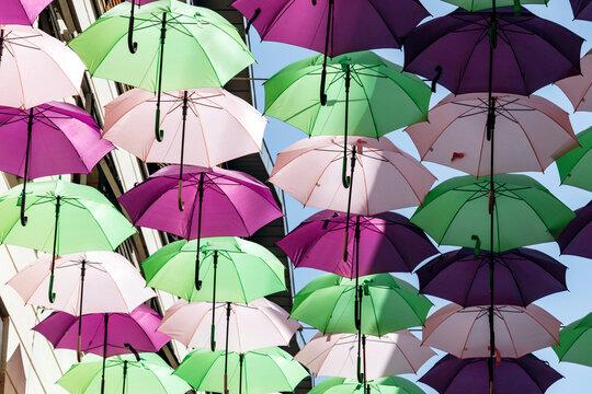 Colorful decorative umbrellas hanging above a street in central Bordeaux, France