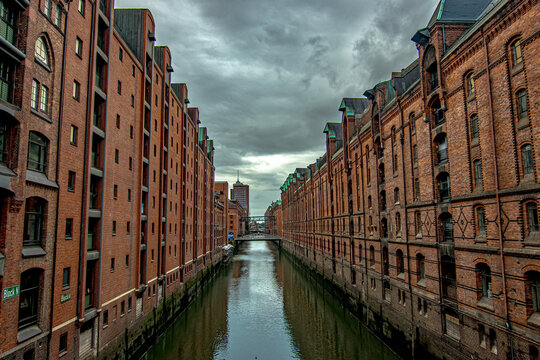 Hamburg Speicherstadt canal reflecting historic brick warehouse buildings