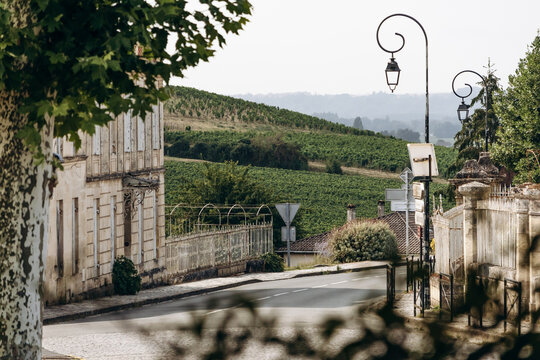 Saint Emilion, France &ndash; July 13, 2026: Historic stone houses and a quiet road overlooking vineyards on the outskirts of the Bordeaux wine town.