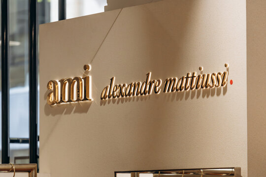 Bordeaux, France - July 14, 2026: Gold AMI Alexandre Mattiussi branding displayed inside the Galeries Lafayette department store in central Bordeaux