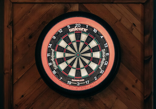 Bordeaux, France - July 14, 2026: Unicorn dartboard mounted on a wooden wall inside The Houses of Parliament pub in central Bordeaux.
