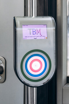 Bordeaux, France - July 14, 2026: TBM contactless ticket validator inside a Bordeaux tram, used by passengers to validate transport cards and tickets.