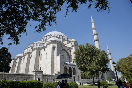 View of the historic Suleymaniye Mosque with its grand dome and minarets, surrounded by lush trees and clear blue sky in Istanbul, Istanbul, Turkey.