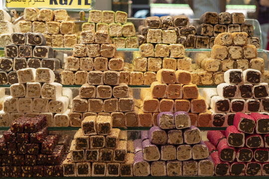 View of various flavors of colorful Turkish delight arranged in neat pyramids on glass shelves in a traditional confectionery shop in Istanbul, Istanbul, Turkiye.
