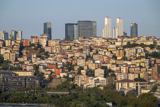 View of the dense urban landscape of Istanbul, featuring a mix of traditional residential buildings and modern skyscrapers under a clear sky in Istanbul, Istanbul, Turkiye.