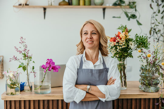 Woman florist apron standing in flower shop business
