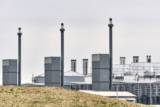Taulov, Syddanmark, Denmark - 28 August 2026: View of Google Datacenter site with industrial cooling towers and backup power plant chimneys under an overcast sky.