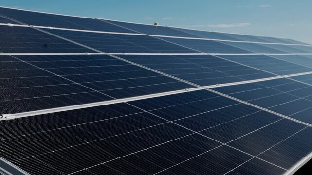 Diagonal rows of solar panels create a graphic composition of modern renewable energy infrastructure.