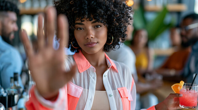 Young woman standing confidently at a party while declining a cocktail, alcohol-free social life, self-confidence, peer pressure resistance, wellness, conscious lifestyle, with