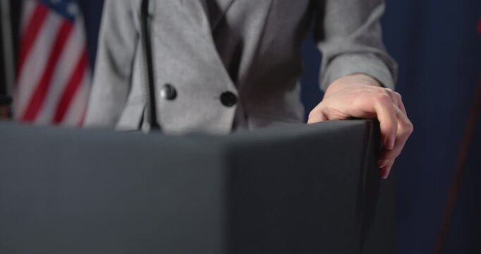 Speaker grips and strikes podium during emotional speech