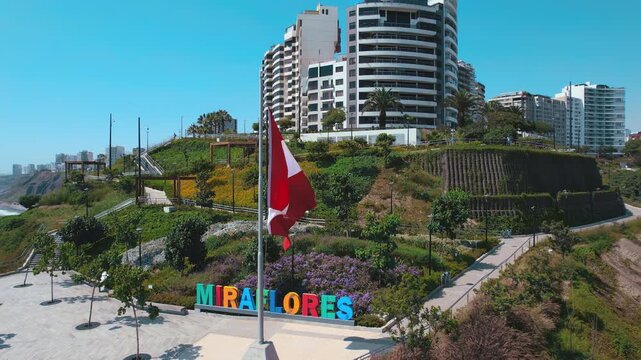 Peruvian Flag Waving Over Miraflores Sign in Lima Peru