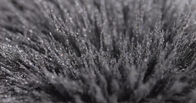 Metal dust, shavings, iron powder under the influence of a magnetic field. Abstract background.