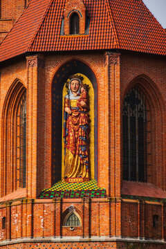 Malbork, Poland - 23 March 2026: View of the ornate Madonna and Child statue set into the red brick wall of the historic Malbork Castle.
