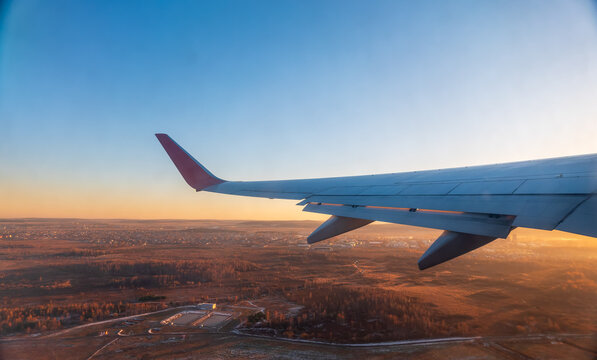 View from the airplane window during taking off on a clear summer morning