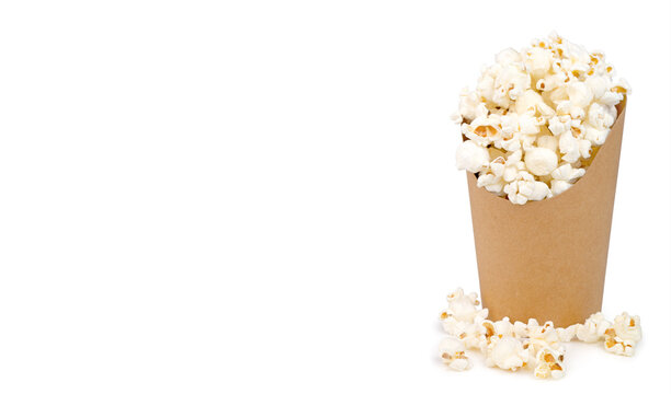 Popcorn in cardboard container with copy space on white background for movie snack concept