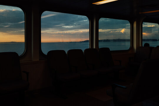 sunset, dusk view from passenger windows on Washington State ferry boat