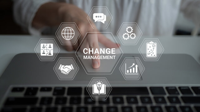 Business professional engaging in change management through technology and digital transformation strategies for effective organizational development. Glyphic.