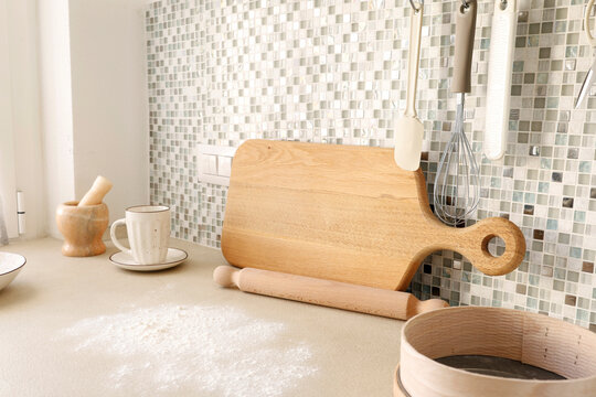 Flour spilled on beige kitchen counter for baking preparation scene. 
