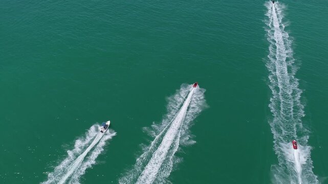 Vacation on summertime. Aerial view at vacation. Jet ski in motion. Summer vacation activity. Water sport activity in summer. Sea beach lifestyle. Beach life concept