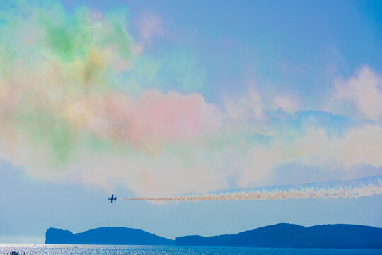Frecce Tricolori aircraft flying over the sea with Capo Caccia in the background