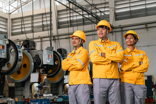 Industrial worker factory worker machinery manufacturing safety helmet protective clothing Asian worker teamwork industrial factory confident expression