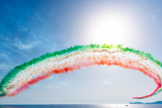 Frecce Tricolori forming a colorful arc over Capo Caccia in Sardinia