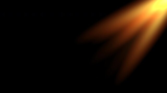 Looping sun rays golden flare light effect with shine on black background