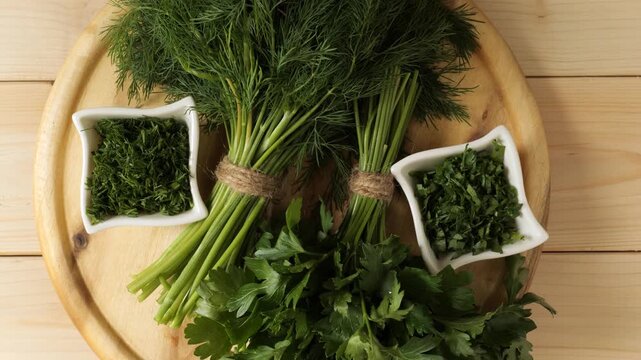 Fresh dill and parsley herbs on a wooden cutting board