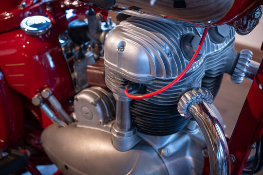 Close-up of the engine of a red vintage motorcycle.