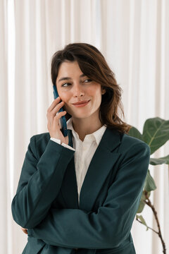 Professional businesswoman talking on phone, smiling