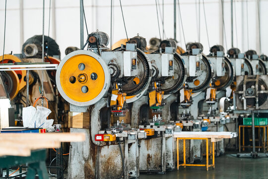 Industrial machine factory interior metal equipment manufacturing machinery production line orange wheel mechanical press textile factory workshop industrial design