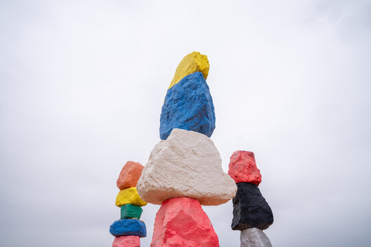 The colorful painted rocks of Seven Magic Mountains on an overcast day in the desert