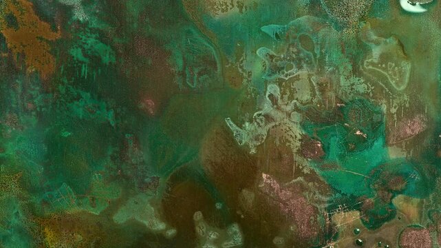 Macro timelapse showing the oxidation and patina formation of copper, with turquoise, green, blue and reddish corrosion patterns evolving across a textured metal surface