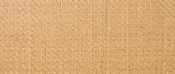 Obraz na płótnie Canvas Natural rattan wallpaper with cane weave pattern. Beige woven wicker texture