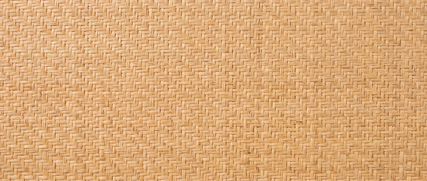 Natural rattan wallpaper with cane weave pattern. Beige woven wicker texture
