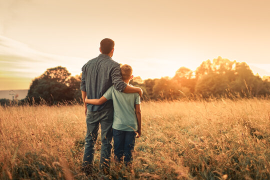 Father and Son Embracing at Sunset Concept of Love, Support, Guidance and Family Bond
