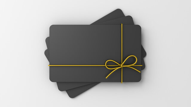 Blank black business gift cards mock up with gold rope ribbon bow isolated on white gray background with shadows and copy space minimal conceptual 3D rendering