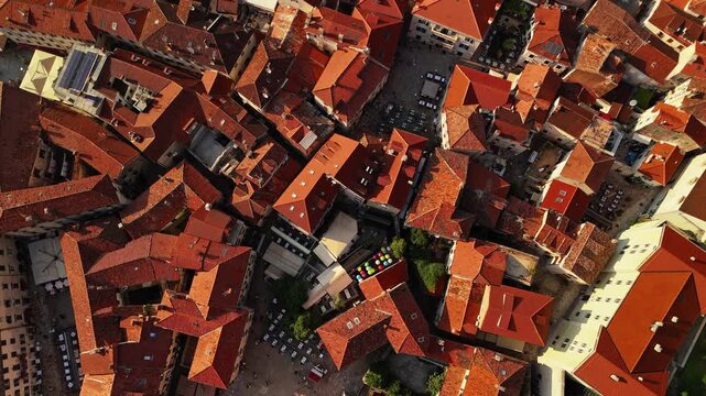 aerial top down view of dense terracotta rooftops, chimneys and narrow alleys forming an abstract pattern, useful as b roll or a textured background, kotor old town, montenegro