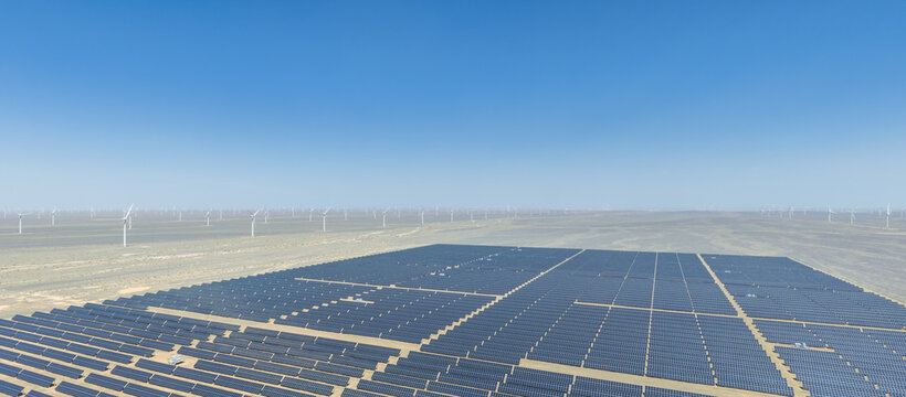 Aerial View of Vast Solar Photovoltaic Plant and Wind Farm in Arid Gobi Desert