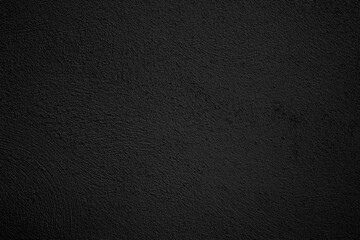  Fondo de estuco de pared texturizado de color negro oscuro. Superficie punteada rugosa, oscura y sólida  transmite minimalismo industrial, sobriedad e interiores modernos. © C.Castilla