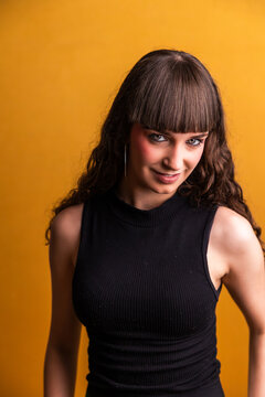 Young woman with bangs smiling looking at camera