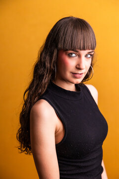 Young woman with bangs and black top posing